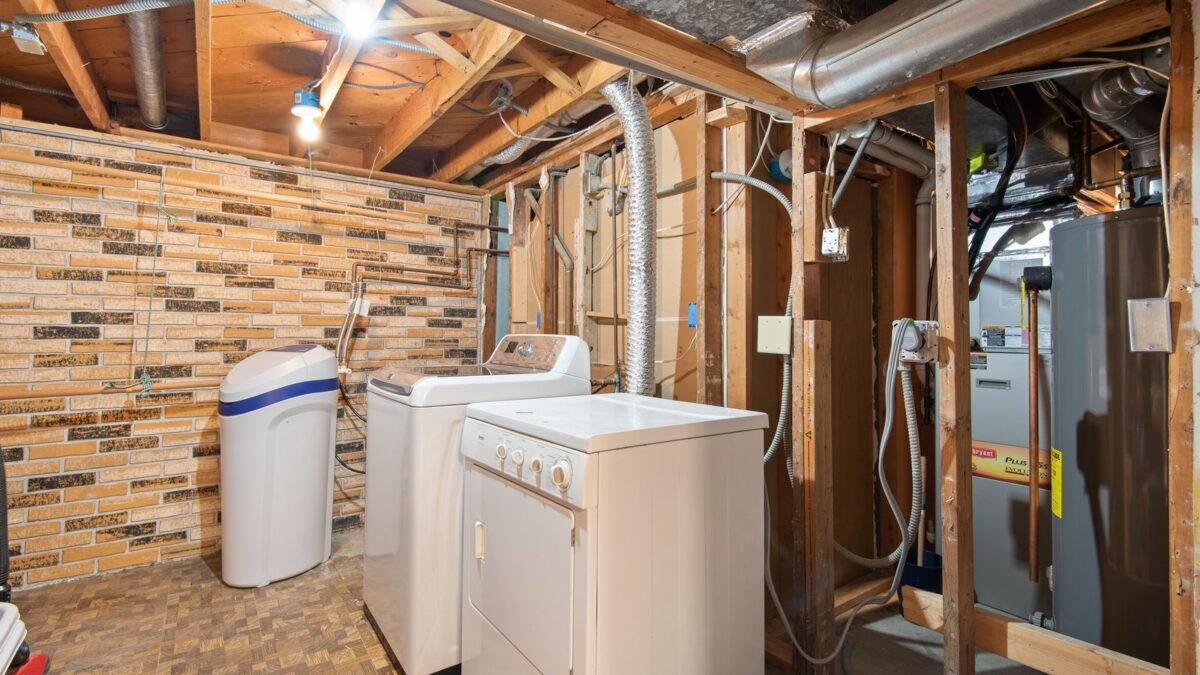 Spacious basement laundry room featuring modern appliances and exposed brickwork, illustrating ao smith water softener review