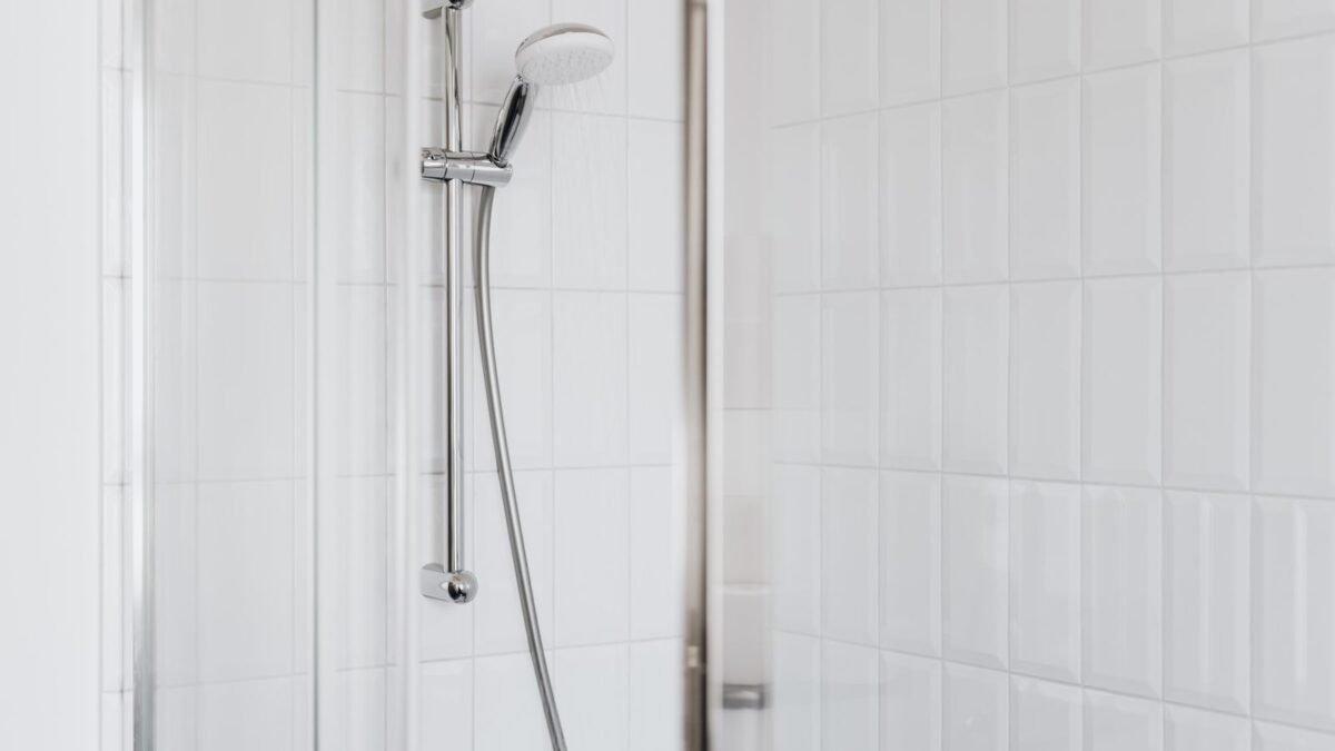 Stylish shower setup with chrome fixtures and clean white tiles, illustrating aquabliss shower filter review