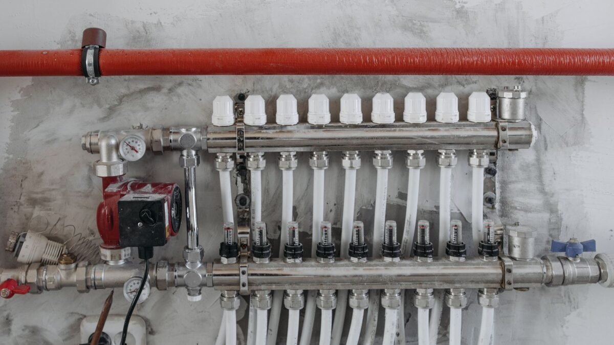 A close-up view of an industrial manifold with pressure gauges and connected steel pipes, illustrating aquasure vs fleck 5600sxt