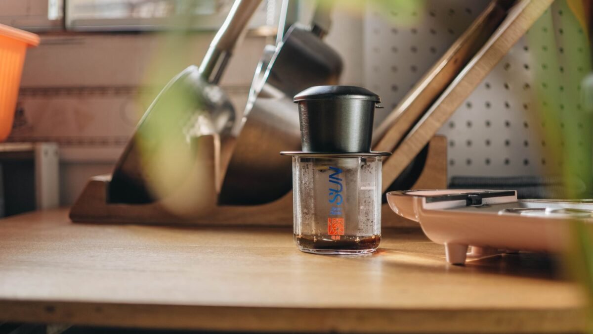 A cozy kitchen featuring a coffee maker and kitchen tools on a wooden counter, emphasizing a wa, illustrating best coffee maker descaler