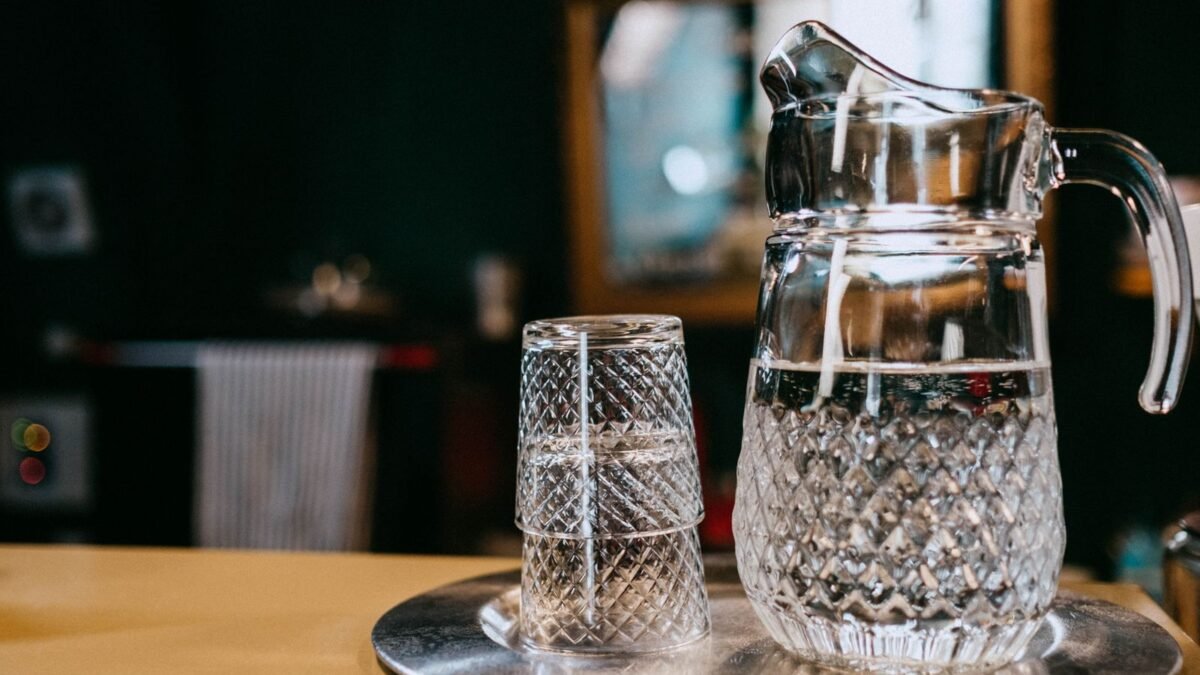 Close-up of a crystal glass pitcher and glasses with water, creating a classic still life setti, illustrating best countertop reverse osmosis system