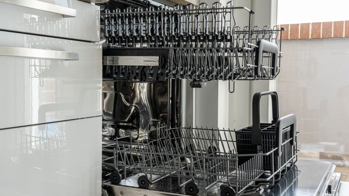 Open and empty dishwasher in a sunlit modern kitchen ready for use, illustrating best dishwasher detergent for hard water