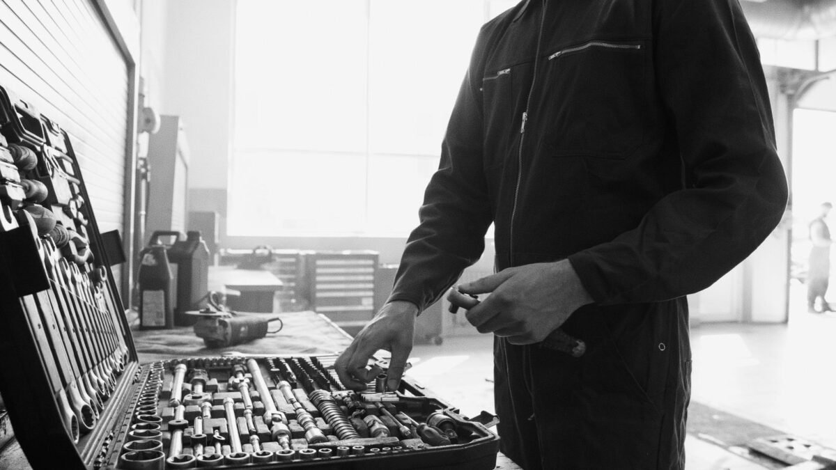 Mechanic in overalls working with a tool set in a garage, illustrating best diy water softener