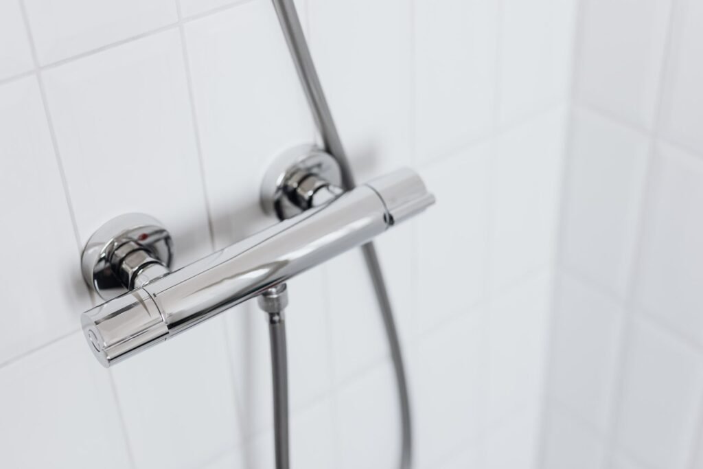Modern chrome shower fixture showing where an inline filter or a filtered head would mount