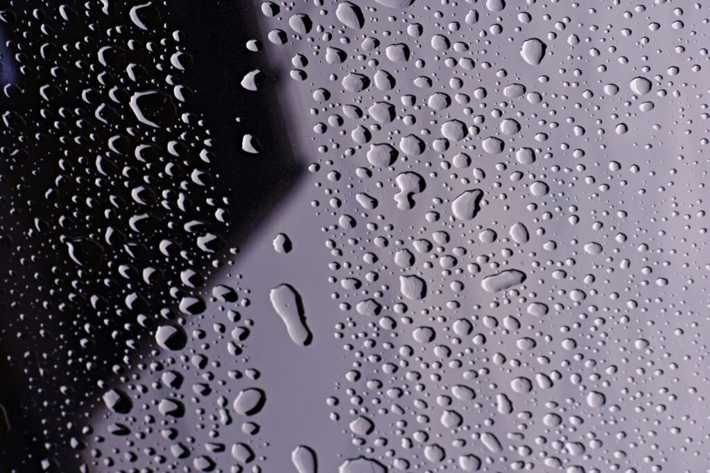Water droplets on glass, the scale at which shower filter media act on chlorine and metals