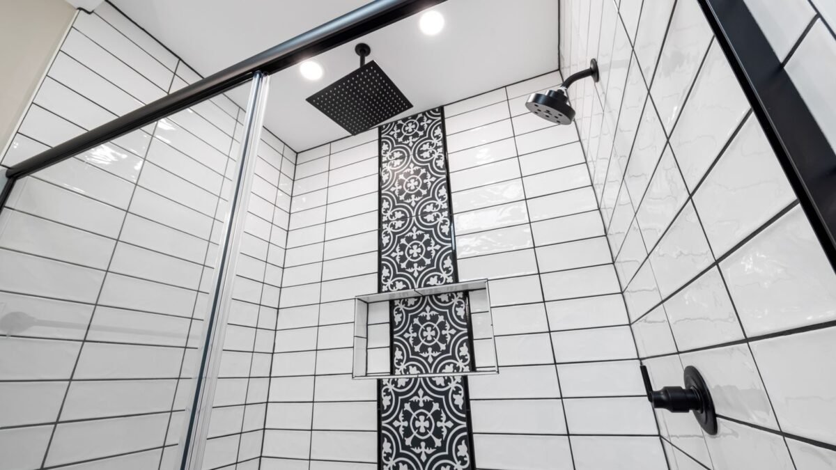 Stylish bathroom with a modern shower featuring a patterned tiled wall and black fixtures, illustrating best shower filter replacement cartridge