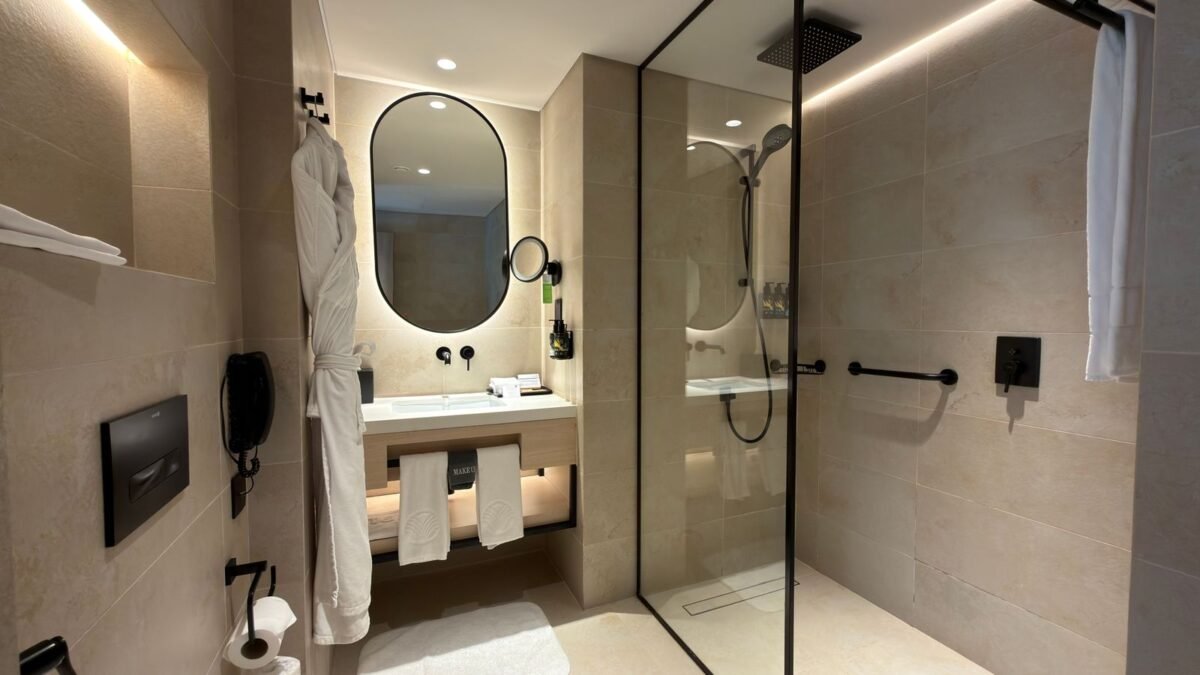 Luxurious hotel bathroom featuring a sleek shower and contemporary fixtures, illustrating best travel shower filter