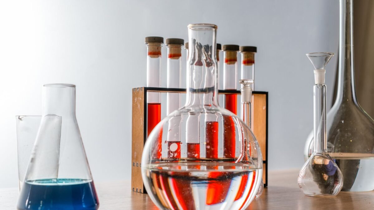 Close-up of various glassware in a lab, highlighting colorful liquids in test tubes, illustrating best water hardness test kit