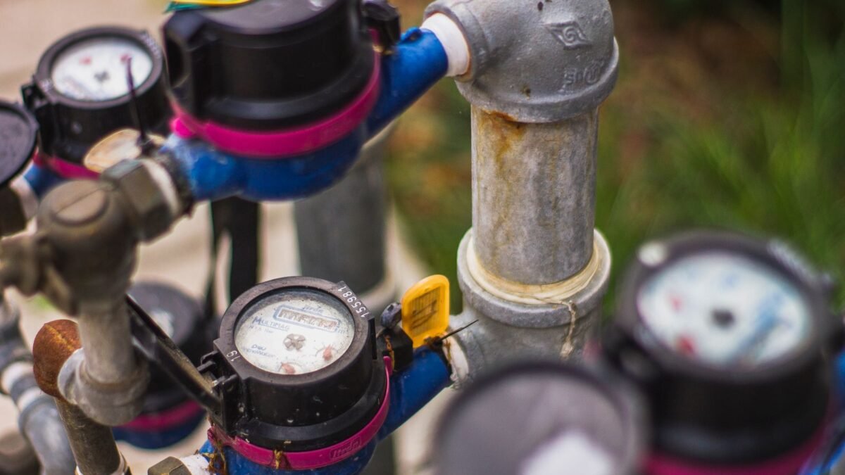 Detailed image of industrial water pressure gauges and pipes in an outdoor setting, illustrating best water pressure regulator