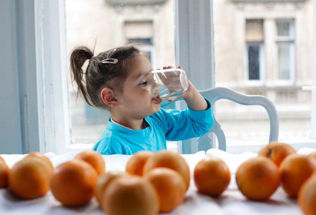 Child drinking a glass of water, a reminder that softened water and drinking water are separate choices