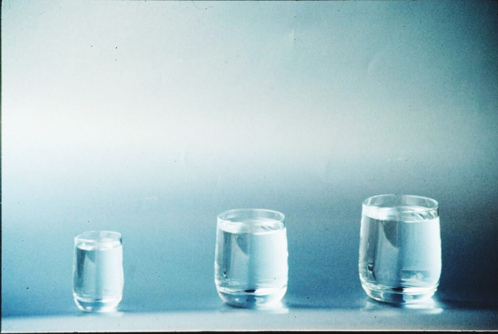 Clear glass of water showing what a whole house softener changes and what it doesn't