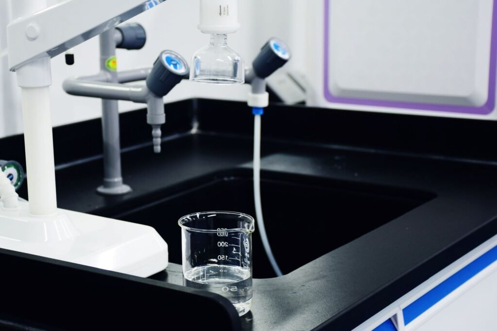 Lab beaker and glassware used to test tap water hardness before choosing a softener size