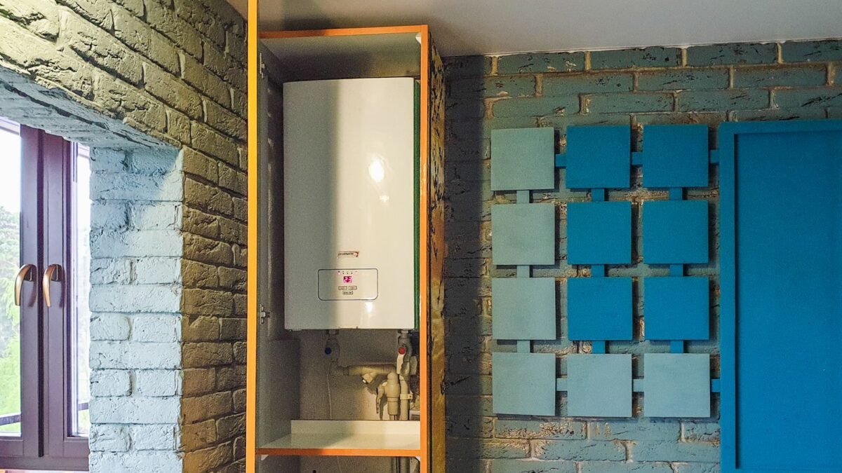 Indoor view of a water heater neatly installed in a cabinet with modern decor, illustrating best water softener for tankless water heater
