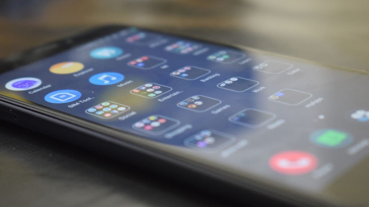 Close-up shot of a smartphone screen showing various app icons, indicating digital technology u, illustrating best water softener salt level sensor
