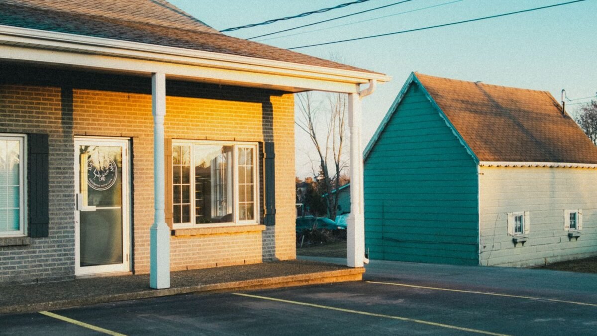 A serene image of suburban buildings and parking lot during golden hour, illustrating best whole house water filter under 500