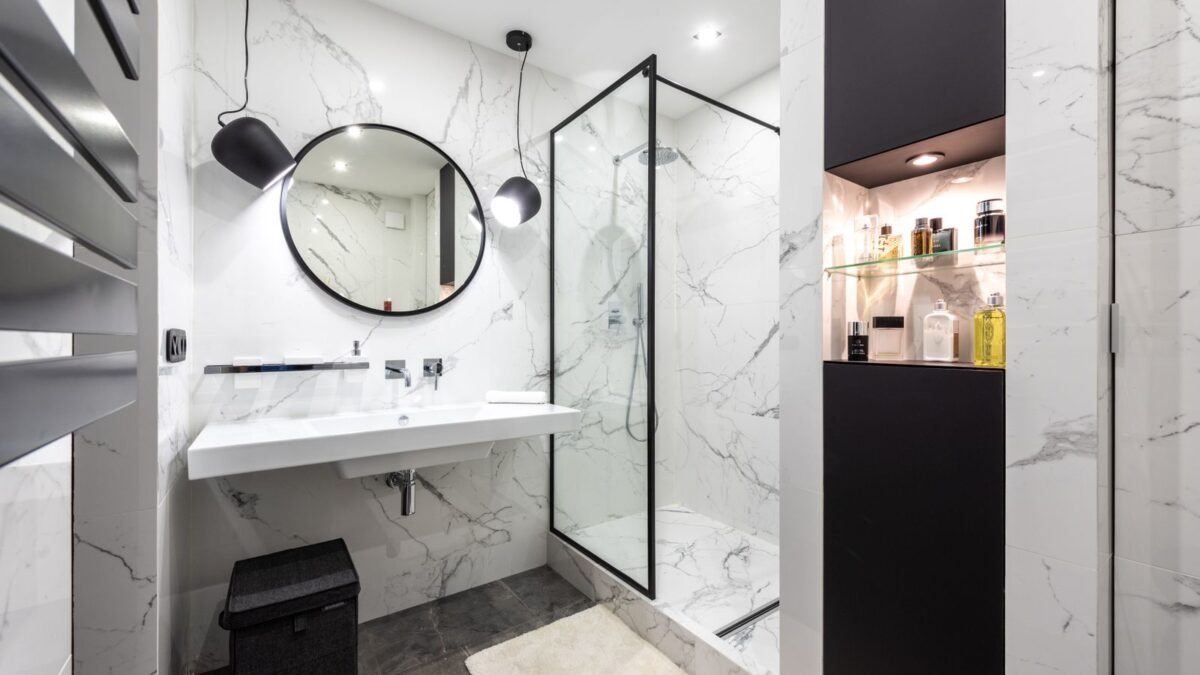 Shower room against washbasin and mirror between shiny lights in bathroom with assorted perfume, illustrating canopy shower filter review