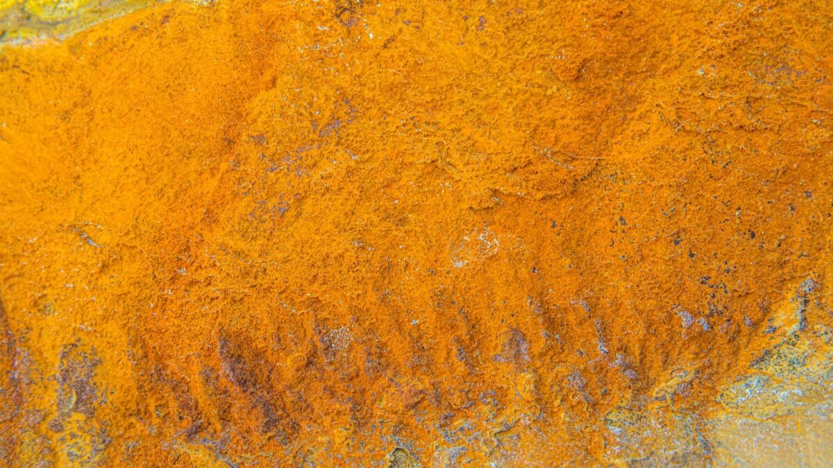 Close-up of a vibrant orange rusty texture on a metal surface, displaying interesting patterns , illustrating iron out vs res care