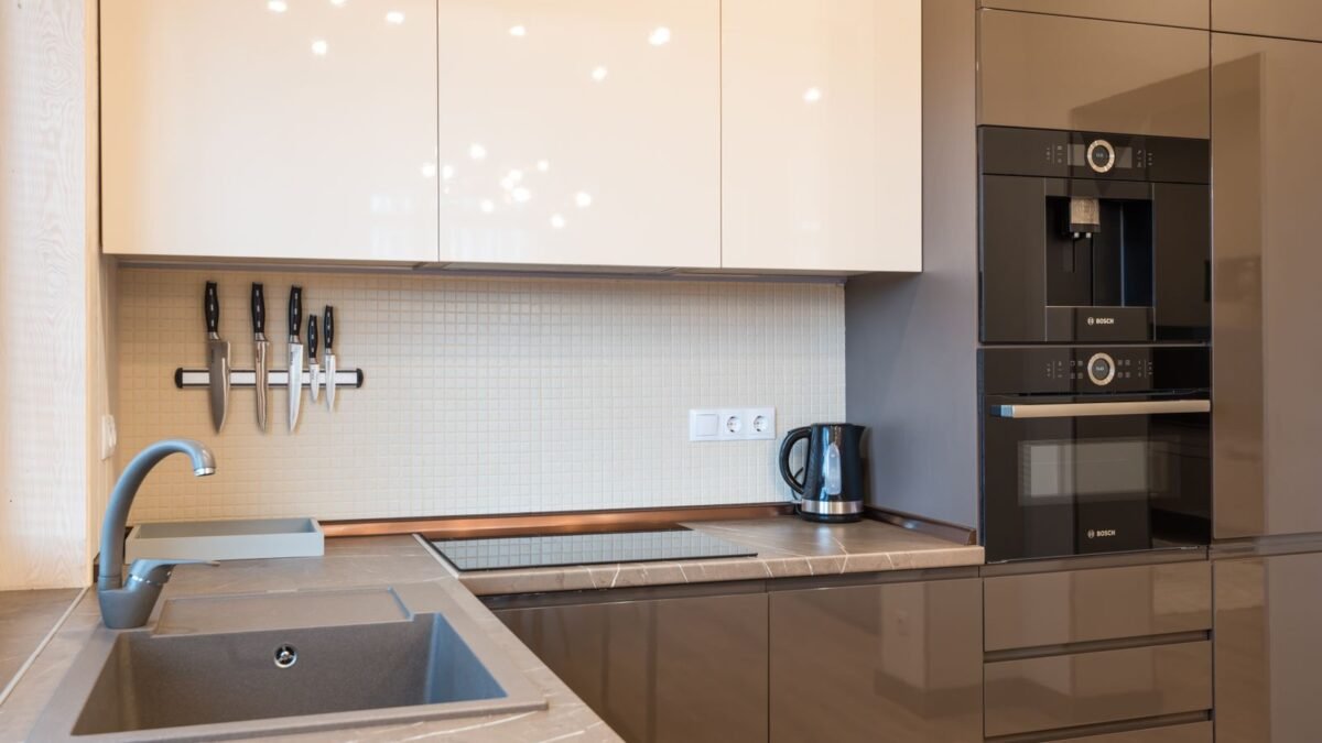 Interior of kitchen with minimalist glossy furniture and modern appliances in light contemporar, illustrating kenmore water softener review