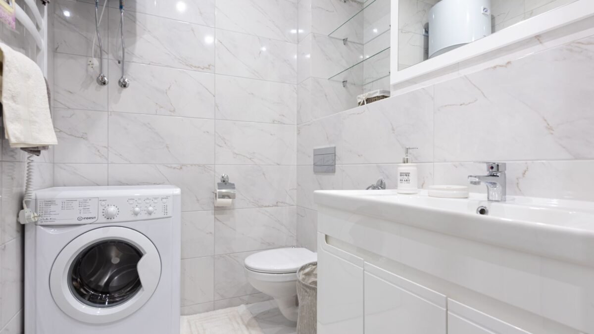 Bright minimalist bathroom featuring a washing machine and modern fixtures, illustrating pentair water softener review