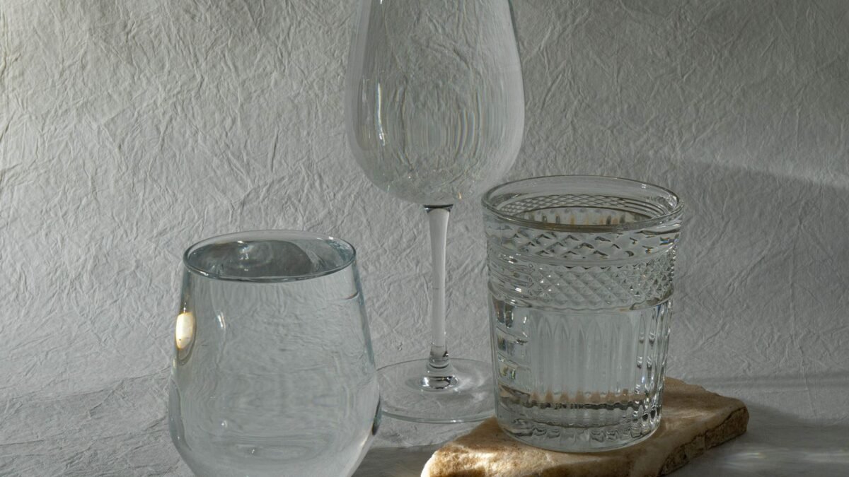 Elegant arrangement of glassware on a textured surface, showcasing light play and transparency, illustrating water-right impression review