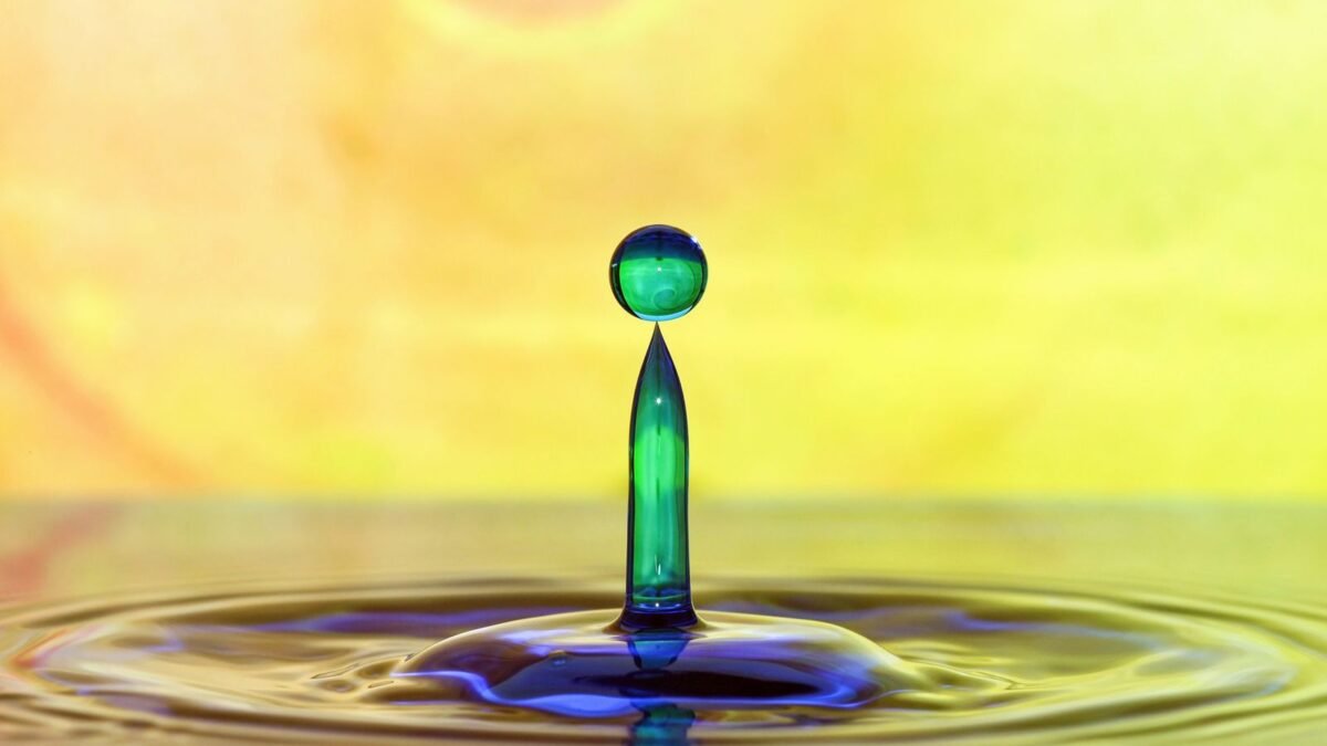 A stunning macro shot capturing a vibrant water droplet in motion, set against a colorful backg, illustrating waterdrop vs ispring ro